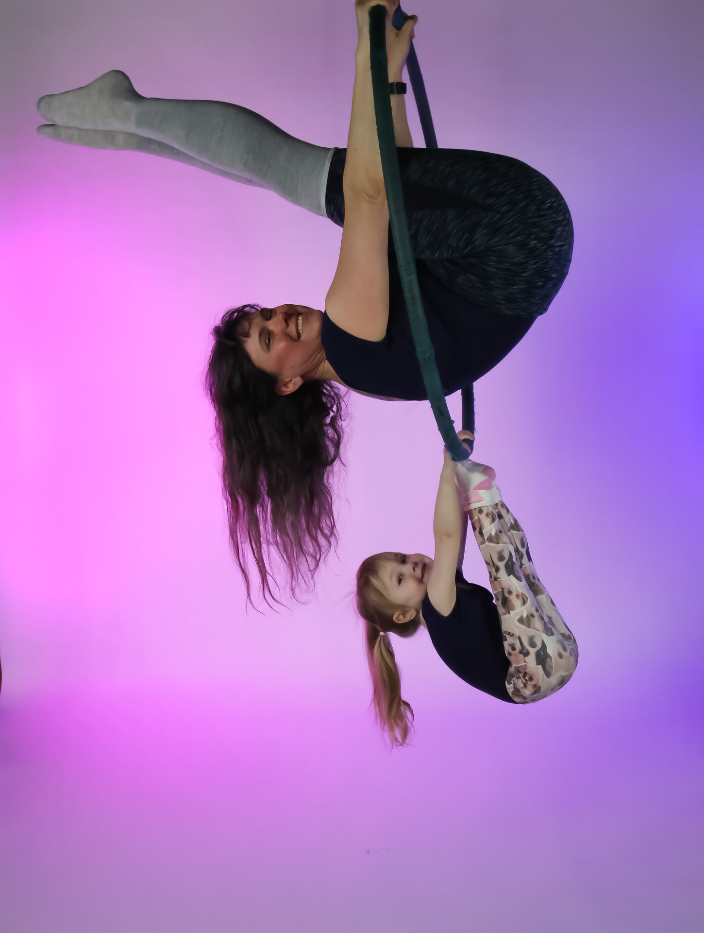 A parent and child sharing an aerial inversion together at Flexibility in Flight